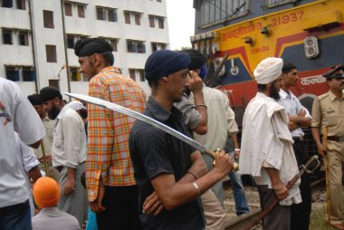 Sikh community block trains protest against firing bodyguard of dera saccha sauda chief ram rahim at Mulund in Bombay Mumbai, Maharashtra, India   clipart