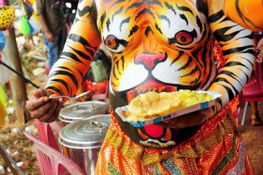 Men eating lunch before Pulikali Tiger Dance, Onam festival, Thrissur, Kerala, India, Asia clipart