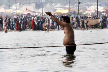 Pilgrims gather at the confluence of the Ganges, Yamuna and the mythical Saraswati rivers to take a holy dip during the Ardh Kumbh Mela, one of the worlds largest religious festivals at Allahabad, Uttar Pradesh, India  clipart