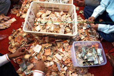 Devotee count cash offering to lalbaug cha raja after ganpati festival ; Bombay Mumbai ; Maharashtra ; India 5-September-2009 clipart