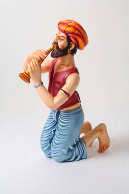 Clay figurine , statue of rajasthani musician playing shehnai clipart