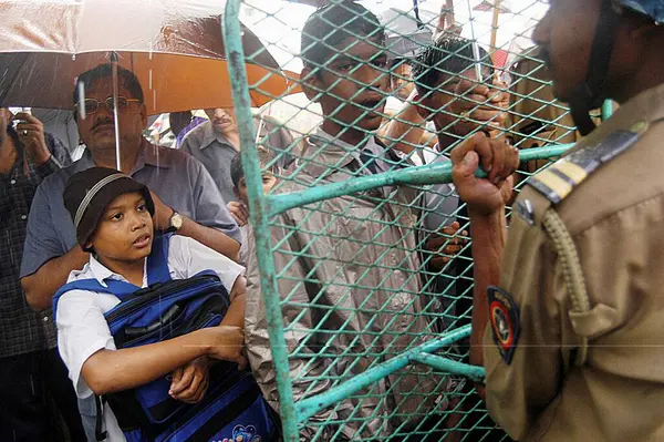 stock image School children with parents holding umbrellas protesting against corruption at New Bombay Navi Mumbai, Maharashtra, India   