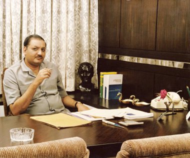 A Portrait of Mr Master of Malda Leasing Co Sitting in his office   clipart