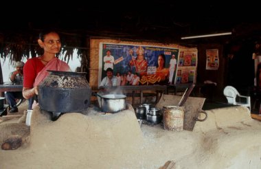 woman making tea ; parnashala ; bhadrachalam ; Andhra Pradesh ; India clipart