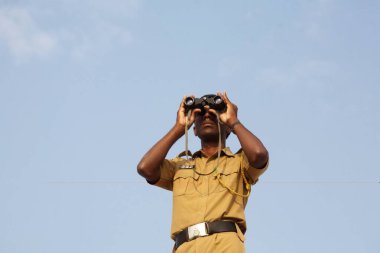 A policeman keeping a watch over the Eid al Fitr or Ramzan id namaaz at Lashkar-e-Eidgaah ground ; Malegaon ; Maharashtra ; India clipart