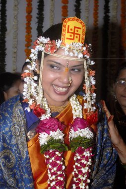 A bride ; laughing ; bridal ornament ; wedding ceremony in Hindu religion at Borivali ; Mumbai Bombay  ; Maharashtra ; India MR clipart