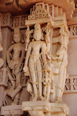 Idols carved in wall stone in deval, Mandore, Jodhpur, Rajasthan, India  clipart