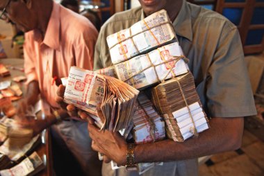 Devotees carry counted cash bundles offering to lalbaug cha raja after ganpati festival, Bombay Mumbai, Maharashtra, India            clipart