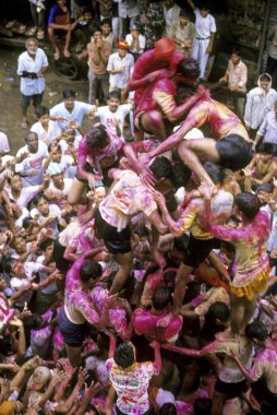 People celebrating Dahi-Hundies, Human Pyramid, Janmashtami janmashtmi gokul ashtami govinda Festival  clipart