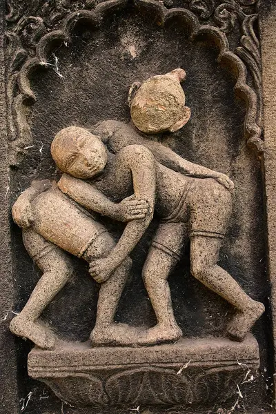 stock image Two wrestlers, carved on the wall of Ahilayabai temple, ornamental carving over stone, old Indian sculpture, Heritage site, in building on Ahilayabai ghat of Narmada river, was named after Ahilayabai, one of the most powerful ruler of Holkar  