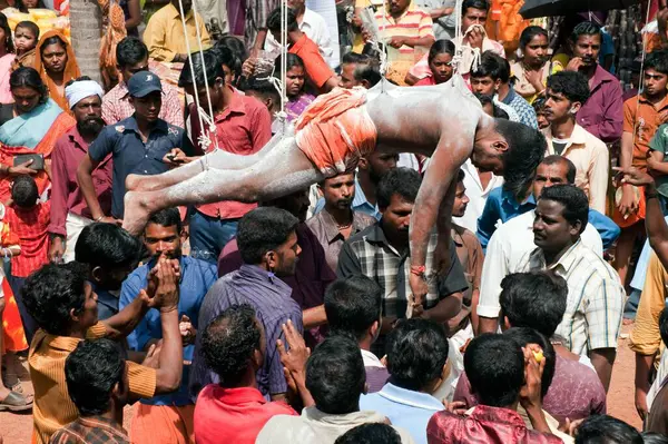 stock image Devotee fulfilling vow by hanging with hooks in Thaipusam festival, Kerala, India   