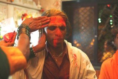 Turmeric or haldi being smeared on forehead of eunuch during wedding of eunuchs on occasion of Bewa Purnima at Ghatkopar ; Bombay now Mumbai ; Maharashtra ; India clipart