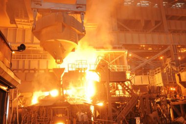 Process of pouring of molten iron inside steel plant ; Essar steel ; Hajira Plant ; Surat ; Gujarat ; India clipart