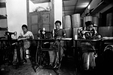 Bodo women stitching on sewing machine, Assam, India  clipart