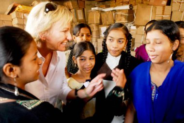 Sabine Christiansen in conversation with young girls at Amrae an NGO at Nehru Nagar, Golibar Slum ;Santacruz ;Bombay Mumbai, Maharashtra, India    clipart