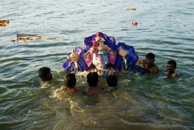 People carrying idol of lord ganesh immersed in pond on ganpati festival , Muthannankulam , Coimbatore , Tamil Nadu , India clipart