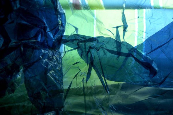 Abstract of blue cellophane paper on colorful plastic shopping bag, Pune, Maharashtra, India 