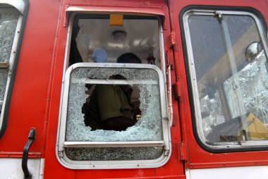 Rioters break and damage the glass pane of a BEST bus after the Dalit community resort to violent protests, Bombay now Mumbai, Maharashtra, India   clipart