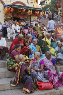 Pilgrims sitting on ghat, varanasi, uttar pradesh, india, asia  clipart