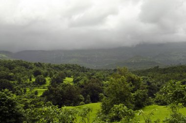 landscape in monsoon with rain clouds looming Raigad Maharashtra India Asia clipart