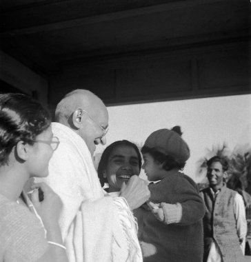 Abha Gandhi and Mahatma Gandhi playing with child at Santiniketan, West Bengal, India, 1945 - MODEL RELEASE NOT AVAILABLE clipart