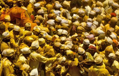 Devotees rushing Khandoba 'palkhi' in frenzied state out of the Jejuri temple, India  clipart