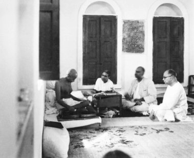 Mahatma Gandhi spinning and talking with Dr Shyam Prasad Mukherjee and others at New Delhi, 1946, India   clipart