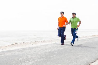 Vijender Singh and Sushil Kumar running on the road India Asia  clipart