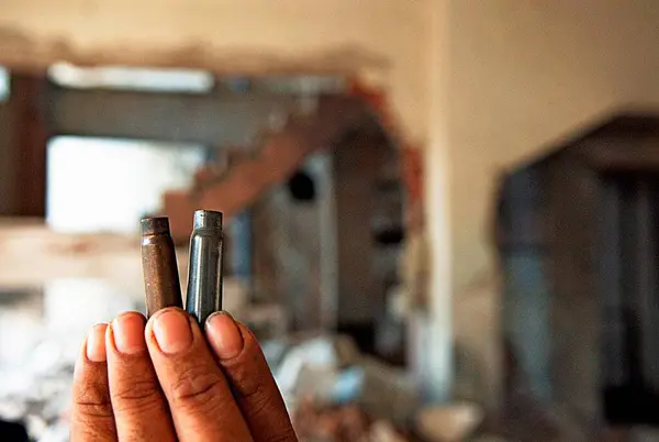stock image Man shows bullets in crossfire at nariman house jewish community centre by deccan mujahedeen terrorists attack in Bombay Mumbai, Maharashtra, India 17 February 2009 