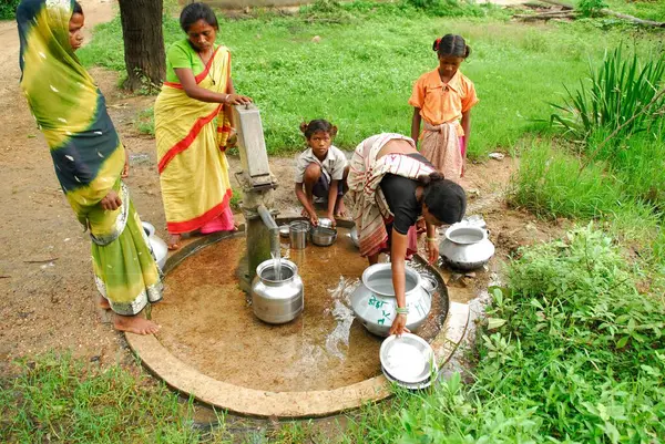 stock image Ho tribes women filling pots with water by handpump. Chakradharpur. Jharkhand. India   