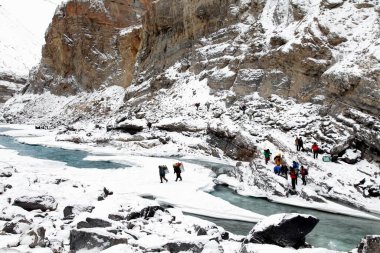 Peoples crossing frozen river, chadar trek, ladakh, jammu and kashmir, india, asia clipart