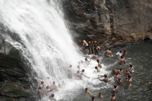 stock image men bathing in Palaruvi waterfall ; Thenmala ; Kerala ; India