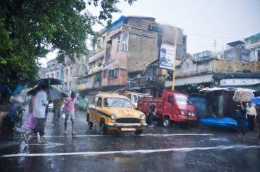 Vehicles on road in monsoon Kolkata India Asia  clipart