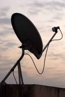 Dish Antenna on terrace of village house ; entertainment through satellite ; village Otur ; Taluka Junnar ; District Pune ; Maharashtra ; India clipart