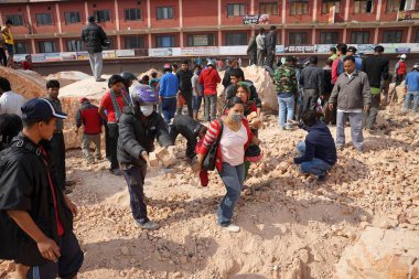 People searching dead bodies base of dharahara, kathmandu, nepal, asia  clipart