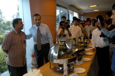 Chairman of Reliance Infocomm now Reliance Communications Anil Ambani with employees at food court    clipart