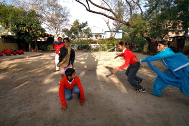 Nanhi Duniya Okulu, Dehradun, Uttaranchal, Hindistan 'da Kho Kho oynayan öğrenciler ve öğretmenler 