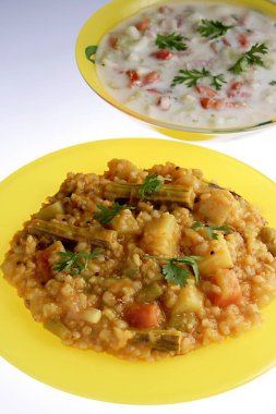 Indian food bisi bele huli ana and pachhadi , south indian rice with dal and vegetables and curd with tomatoes onions coriander clipart