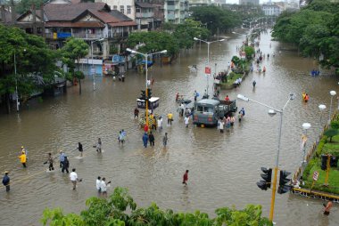 Monsoon ; people walking through flooded road heavy rain in Parel; Bombay Mumbai ; Maharashtra ; India clipart