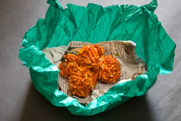 stock image Indian festival sweets. Ladoo balls in newspaper with green paper 