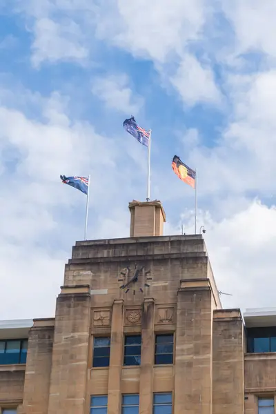 Australian government building with the national and aboriginal flag raised.