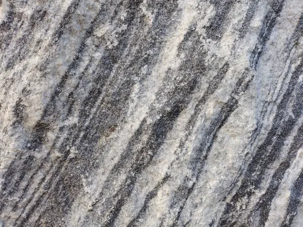 Texture of a stone, white and grey lines, macro shot