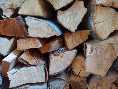 macro shot of piled up logs for use for heating. Front of different pieces of wood. Piles of chopped firewood, angular, round, dry.  clipart