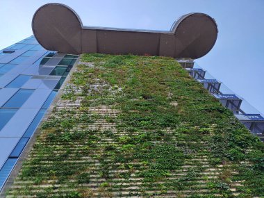 Vienna, Austria, June 17, 2024: Closeup of green facade of Aqua Terra Zoo, a former World War Two flak (anti aircraft) tower. Zoo founded 1957. Vertical planting. Conversion of old building. Haus des Meeres