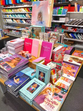 Viyana, Avusturya, 27 Haziran 2024: Taylor Swift hakkında farklı türde kitaplar ve hatıralar, Avusturya 'daki Thalia adlı bir kitapçıda sergileniyor. Dikey görüntü, iç mekan. Başarılı ABD 'li sanatçı ve iş kadını.