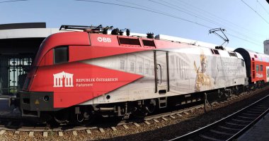 Gaenserndorf, Austria, August, 25, 2024: OEBB (austrian railways) electric locomotive 1116200-7 manufactured by Siemens with noticeable design: Democracy in Motion. Promoting the Austrian Parliament. clipart