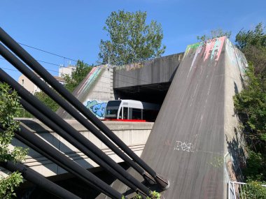 Wien, Austria-August 25, 2024: Subway line U6 exits tunnel at Spittelauer Bridge above river Donaukanal at Viennas 20th district Brigittenau. Operated by over head wire. Urban, modern view, summerday clipart