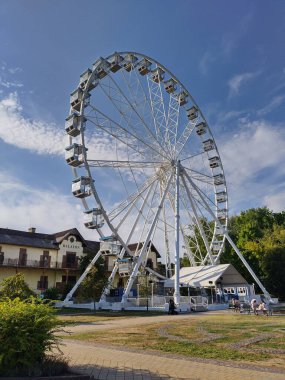 Keszthely, Hungary, August 8, 2024: 50 meter high Giant Ferris Wheel of Keszthely at Balaton shore. Lake Balaton is the largest lake in Central Europe, also called Hungarian Sea. Vertical image. clipart