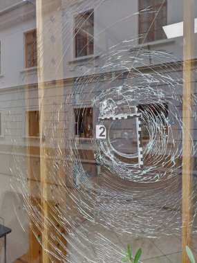 Crime scene investigation. Taking measurements of bursted glass at shop display. Destroyed window at business. Secure evidence after lawless incident. Processing of crime scene. Vertical Picture. clipart