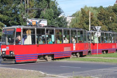 Szczecin, Polonya - 26 Ağustos 2009: Güneşli bir yaz gününde Szczecin 'de yol geçen yolcularla dolu kırmızı retro tramvay modeli Tatra KT4. Nadir kadın sürücü..